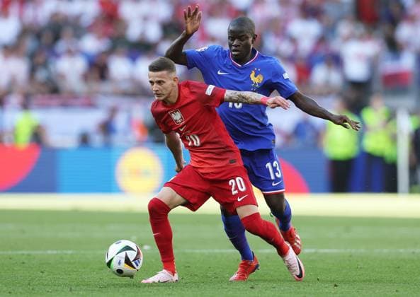 Sebastian Szymanski of Poland is challenged by Ngolo KantÃ of France France v Poland, UEFA European Championship, EM, Europameisterschaft 2024, Group D, Football, BVB Stadion, Dortmund, Germany, 25 Jun 2024 EDITORIAL USE ONLY No use with unauthorised audio, video, data, fixture lists, club league logos or live services. Online in-match use limited to 120 images, no video emulation. No use in betting, games or single club league player publications.  Copyright: xPaulxCurrie Shutterstockx 14555523bo