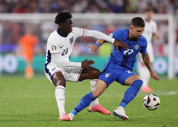 Cologne, Germany, 25th June 2024. Kobbie Mainoo of England challenges Adam Gnezda Äaerin of Slovenia during the UEFA European Championships match at Cologne Stadium, Cologne. Picture credit should read: David Klein Sportimage EDITORIAL USE ONLY. No use with unauthorised audio, video, data, fixture lists, club league logos or live services. Online in-match use limited to 120 images, no video emulation. No use in betting, games or single club league player publications. SPI-3205-0085