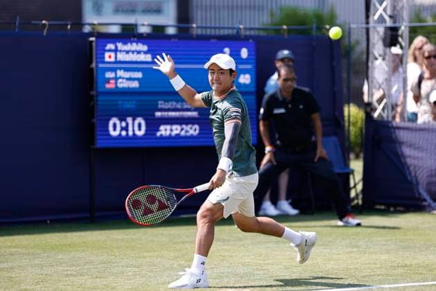 26th June 2024; Devonshire Park, Eastbourne, East Sussex, England: Rothesay International Eastbourne, Day 3; Yoshihito Nishioka (JPN) plays a backhand against Marcos Giron (USA) , mens singles match  ActionPlus12660704 HongboxChen