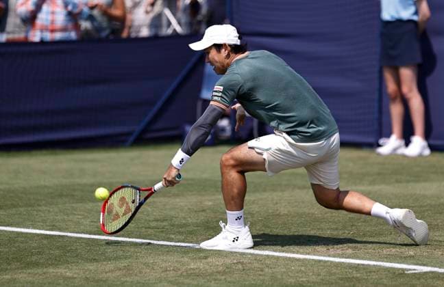26th June 2024; Devonshire Park, Eastbourne, East Sussex, England: Rothesay International Eastbourne, Day 3; Yoshihito Nishioka (JPN) plays a backhand against Marcos Giron (USA) , mens singles match  ActionPlus12660710 HongboxChen