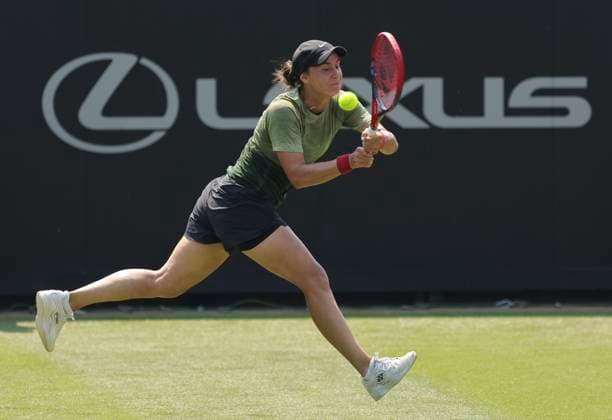 26th June 2024; Devonshire Park, Eastbourne, East Sussex, England: Rothesay International Eastbourne, Day 3, Anhelina Kalinina (UKR) plays a backhand against Madison Keys (USA) , womens singles match  ActionPlus12660696 HongboxChen