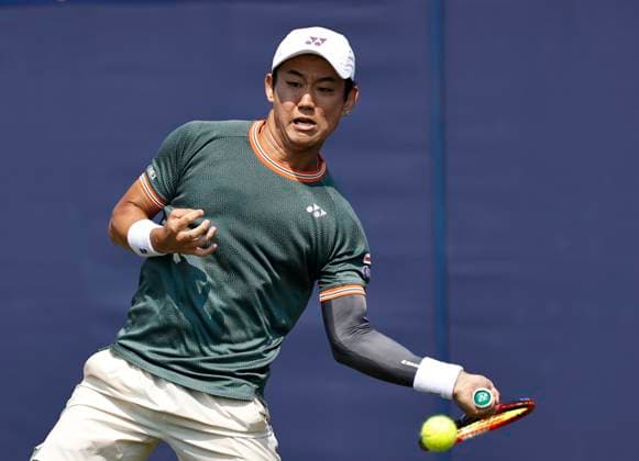 26th June 2024; Devonshire Park, Eastbourne, East Sussex, England: Rothesay International Eastbourne, Day 3; Yoshihito Nishioka (JPN) plays a forehand against Marcos Giron (USA) , mens singles match  ActionPlus12660717 HongboxChen