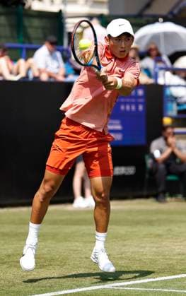 26th June 2024; Devonshire Park, Eastbourne, East Sussex, England: Rothesay International Eastbourne, Day 3; Juncheng Shang (CHN) plays a backhand against Emil Ruusuvuori (Fin), mens singles match  ActionPlus12660812 HongboxChen