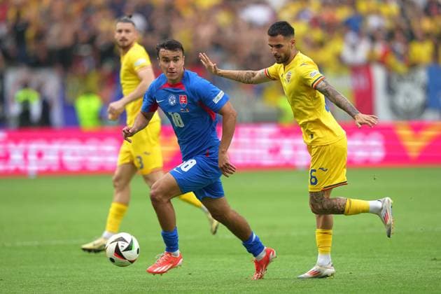 Romania s Marius Marin ight for the ball with Slovakia s David Strelec during the Euro 2024 soccer match between Slovakia and Romania at the Frankfurt Arena , Frankfurt , Germany - Wednesday 26 June 2024. - Soccer .  Copyright: xSpada LaPressex