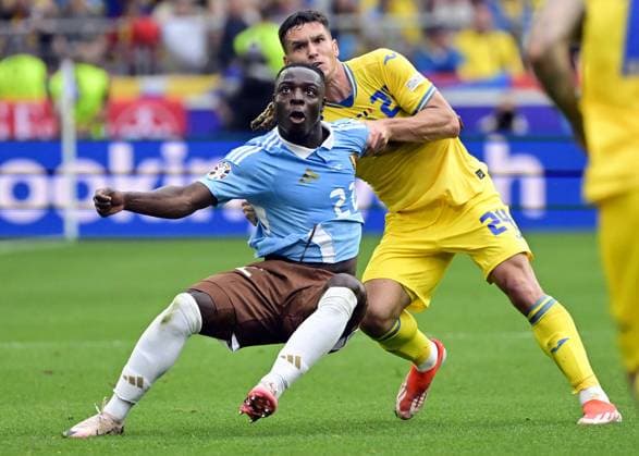 Belgium s Jeremy Doku and Ukraine s Oleksandr Tymchyk pictured in action during a soccer game between Ukraine and Belgian national soccer team Red Devils, Wednesday 26 June 2024 in Stuttgart, Germany, the third match in the group stage of the UEFA EURO, EM, Europameisterschaft,Fussball 2024 European championships. DIRKxWAEM  x95326483x