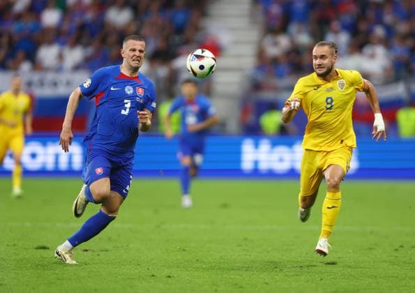 Denis Vavro of Slovakia and George Puscas of Romania chase the ball Slovakia v Romania, UEFA European Championship, EM, Europameisterschaft 2024, Group E, Football, Frankfurt Arena, Frankfurt am Main, Germany - 26 Jun 2024 EDITORIAL USE ONLY No use with unauthorised audio, video, data, fixture lists, club league logos or live services. Online in-match use limited to 120 images, no video emulation. No use in betting, games or single club league player publications. Copyright: xKieranxMcManus Shutterstockx 14555603bc