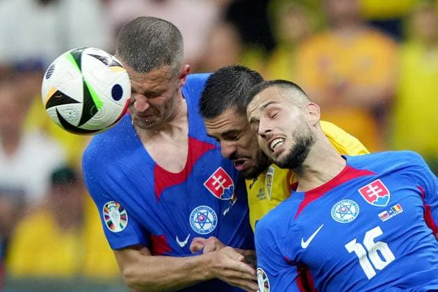 Slovakia s David Hancko , Slovakia s Denis Vavro figt for the ball with Romania s Andrei Burca during the Euro 2024 soccer match between Slovakia and Romania at the Frankfurt Arena , Frankfurt , Germany - Wednesday 26 June 2024. - Soccer .  Copyright: xSpada LaPressex