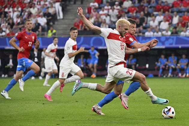 From left Baris Yilmaz of Turkey and Czech Adam Hlozek in action during the Group F match of the European Football Championship: Turkey vs Czechia, in Hamburg, Germany, on June 26, 2024. (CTKxPhoto VitxSimanek) CTKPhotoP2024062609366  CTKPhotoP2024062609366