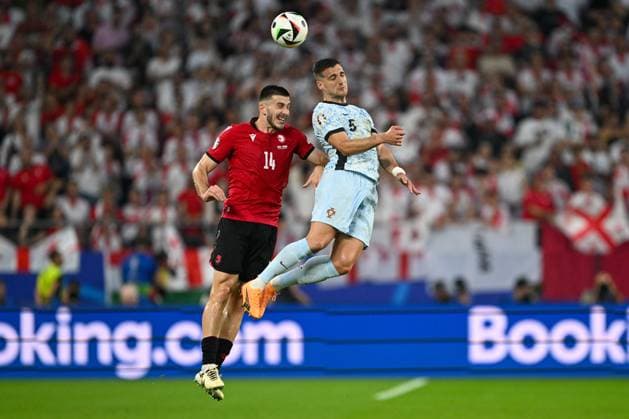 European Championship 2024 Georgia Portugal on 26 06 2024 in the Veltins Arena in Gelsenkirchen Solomon Kvirkvelia 5 of Georgia and Goncalo Inacio 14 of Portugal battle for the ball MT