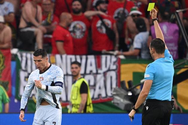 Germany Soccer Euro 2024 Georgia - Portugal 8716981 26.06.2024 Referee Sandro Scharer, right, shows a yellow card to Portugal s Cristiano Ronaldo during the UEFA EURO, EM, Europameisterschaft,Fussball 2024 Group F soccer match between Georgia and Portugal at the Veltins-Arena in Gelsenkirchen, Germany. Alexey Filippov Sputnik Gelsenkirchen Germany  Copyright: xAlexeyxFilippovx