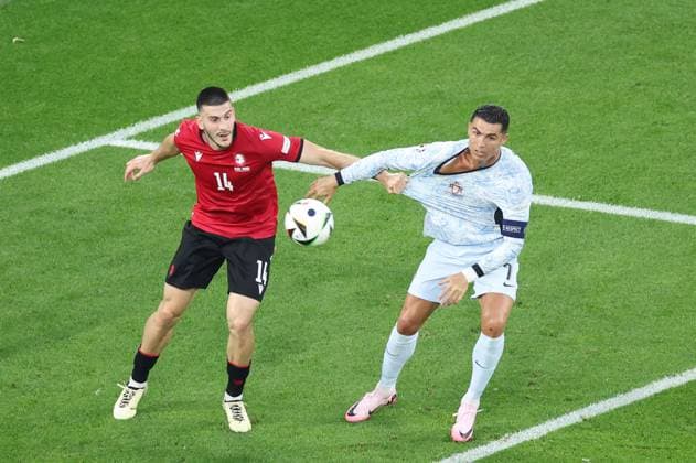 (240627) -- GELSENKIRCHEN, June 27, 2024 -- Cristiano Ronaldo (R) of Portugal vies with Luka Lochoshvili of Georgia during the UEFA EURO, EM, Europameisterschaft,Fussball 2024 Group F match between Portugal and Georgia in Gelsenkirchen, Germany on June 26, 2024. ) (SP)GERMANY-GELSENKIRCHEN-FOOTBALL-EURO 2024-PORTUGAL VS GEORGIA BaixXuefei 