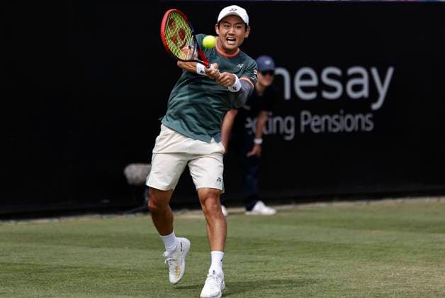 27th June 2024; Devonshire Park, Eastbourne, East Sussex, England: Rothesay International Eastbourne, Day 4; Yoshihito Nishioka (JPN) plays a backhand against Aleksandar Vukic (AUS) in the quarter finals match  ActionPlus12661121 HongboxChen