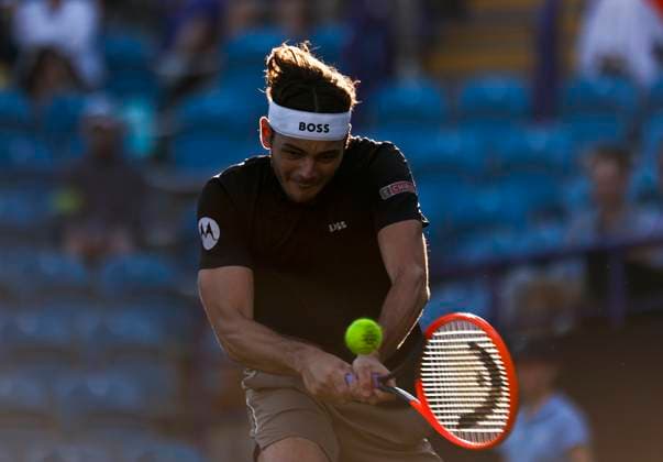 27th June 2024; Devonshire Park, Eastbourne, East Sussex, England: Rothesay International Eastbourne, Day 4; Taylor Fritz (USA) plays a backhand against Juncheng Shang (CHN) in the quarter-final match  ActionPlus12661168 HongboxChen
