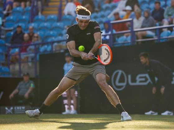 27th June 2024; Devonshire Park, Eastbourne, East Sussex, England: Rothesay International Eastbourne, Day 4; Taylor Fritz (USA) plays a backhand against Juncheng Shang (CHN) in the quarter-final match  ActionPlus12661169 HongboxChen