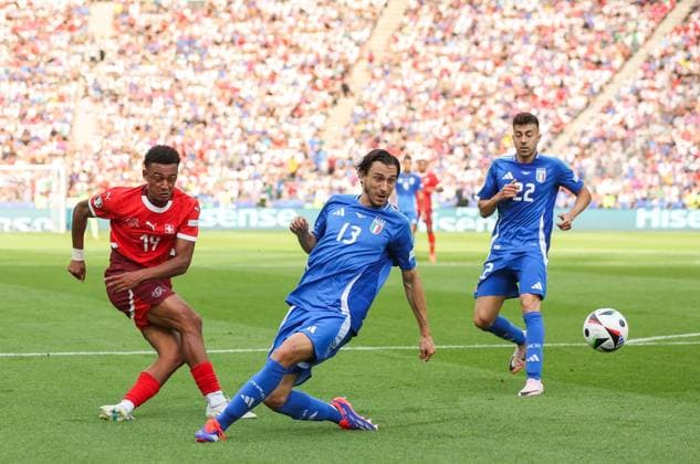 Mateo Retegui of Italy shoots at goal as Matteo Darmian of Italy blocks Switzerland v Italy, UEFA European Championship, EM, Europameisterschaft 2024, Round of 16, Football, Olympiastadion, Berlin, Germany - 29 Jun 2024 EDITORIAL USE ONLY No use with unauthorised audio, video, data, fixture lists, club league logos or live services. Online in-match use limited to 120 images, no video emulation. No use in betting, games or single club league player publications. Copyright: xPaulxCurrie Shutterstockx 14562043ax