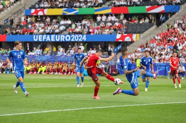 Remo Freuler of Switzerland scores the opening goal 1-0 as Gianluca Mancini of Italy blocks Switzerland v Italy, UEFA European Championship, EM, Europameisterschaft 2024, Round of 16, Football, Olympiastadion, Berlin, Germany - 29 Jun 2024 EDITORIAL USE ONLY No use with unauthorised audio, video, data, fixture lists, club league logos or live services. Online in-match use limited to 120 images, no video emulation. No use in betting, games or single club league player publications. Copyright: xPaulxCurrie Shutterstockx 14562043ba