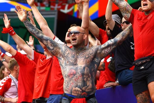 A tattooed Denmark fan cheers on their team ahead of kick off Germany v Denmark, UEFA European Championship, EM, Europameisterschaft 2024, Round of 16, Football, BVB Stadion, Dortmund, Germany - 29 Jun 2024 EDITORIAL USE ONLY No use with unauthorised audio, video, data, fixture lists, club league logos or live services. Online in-match use limited to 120 images, no video emulation. No use in betting, games or single club league player publications. Copyright: xKieranxMcManus Shutterstockx 14562066c