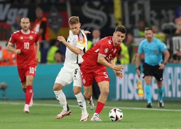 Dortmund, Germany, 29th June 2024. Joshua Kimmich of Germany tussles with Joakim Maehle of Denmark during the UEFA European Championships Group 16 match at the BVB Stadion, Dortmund. Picture credit should read: Paul Terry Sportimage EDITORIAL USE ONLY. No use with unauthorised audio, video, data, fixture lists, club league logos or live services. Online in-match use limited to 120 images, no video emulation. No use in betting, games or single club league player publications. SPI-3213-0024