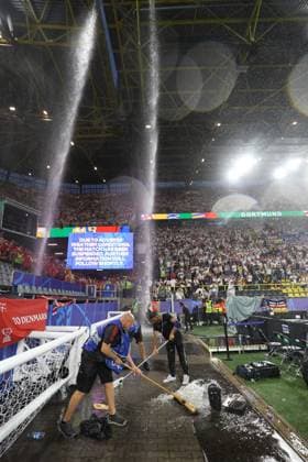 Groundstaff clear Hale Stones and Ice from the side of the pitch as water pours through the roof Germany v Denmark, UEFA European Championship, EM, Europameisterschaft 2024, Round of 16, Football, BVB Stadion, Dortmund, Germany - 29 Jun 2024 EDITORIAL USE ONLY No use with unauthorised audio, video, data, fixture lists, club league logos or live services. Online in-match use limited to 120 images, no video emulation. No use in betting, games or single club league player publications. Copyright: xKieranxMcManus Shutterstockx 14562066ax