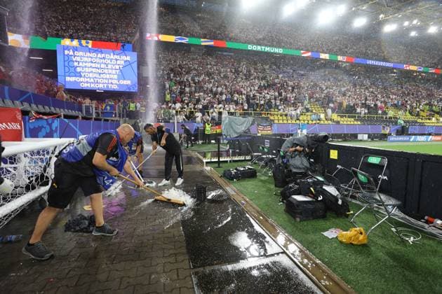 Groundstaff clear Hale Stones and Ice from the side of the pitch as water pours through the roof Germany v Denmark, UEFA European Championship, EM, Europameisterschaft 2024, Round of 16, Football, BVB Stadion, Dortmund, Germany - 29 Jun 2024 EDITORIAL USE ONLY No use with unauthorised audio, video, data, fixture lists, club league logos or live services. Online in-match use limited to 120 images, no video emulation. No use in betting, games or single club league player publications. Copyright: xKieranxMcManus Shutterstockx 14562066aw