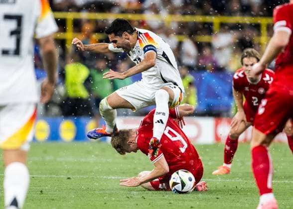 Dortmund, Signal Iduna Park, 29 06 2024 Ilkay Guendogan of germany challenges Rasmus Hoejlund of denmark during the match UEFA European Championship 2024 Germany v Denmark