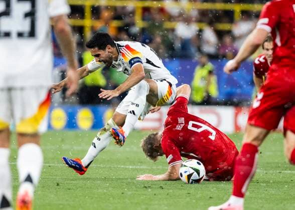 Dortmund, Signal Iduna Park, 29 06 2024 Ilkay Guendogan of germany challenges Rasmus Hoejlund of denmark during the match UEFA European Championship 2024 Germany v Denmark