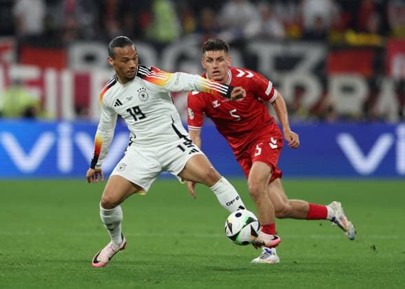 Dortmund, Germany, 29th June 2024. Leroy Sane of Germany tussles with Joakim Maehle of Denmark during the UEFA European Championships Group 16 match at the BVB Stadion, Dortmund. Picture credit should read: Paul Terry Sportimage EDITORIAL USE ONLY. No use with unauthorised audio, video, data, fixture lists, club league logos or live services. Online in-match use limited to 120 images, no video emulation. No use in betting, games or single club league player publications. SPI-3213-0050