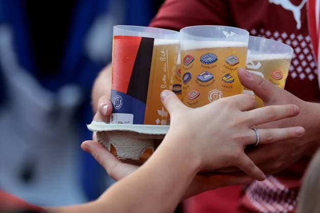 Berlin, Germany, 29th June 2024. Switzerland fans distribute plastic beakers containing beer during the UEFA European Championships Round of 16 match at Olympiastadion, Berlin. Picture credit should read: Jonathan Moscrop Sportimage EDITORIAL USE ONLY. No use with unauthorised audio, video, data, fixture lists, club league logos or live services. Online in-match use limited to 120 images, no video emulation. No use in betting, games or single club league player publications. SPI-3208-0069