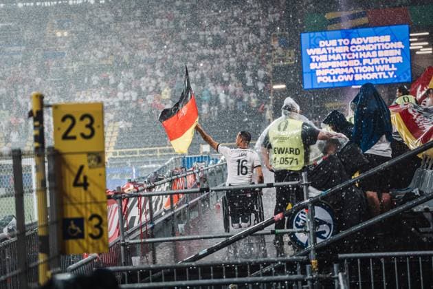 Soccer Men UEFA European Football Championship 2024 Round of 16 Germany vs Denmark 29 06 2024 A fan waves the flag in the rain Dortmund BVB Stadium Dortmund North Rhine-Westphalia Germany