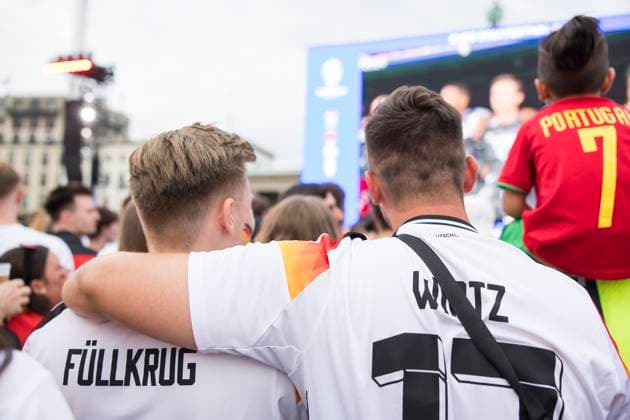 European Football Championship, fan zone at the Brandenburg Gate, Berlin, 29 06 2024 Two fans of the German team lie in each others arms during the national anthem at the fan zone at the Brandenburg Gate during the round of 16 match Germany Denmark at the European Football Championship, Berlin, 29 06 2024 Berlin fan zone Copyright: xBenxKriemannx
