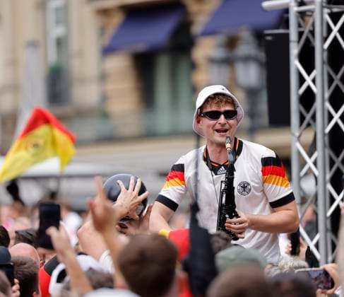 Germany Hesse Frankfurt am Main 23 06 2024 European Football Championship 2024 European Championship type with the saxophone, saxophonist in Völler jersey, Andre Schnura with the black saxophone Sport Public Viewing in Frankfurt