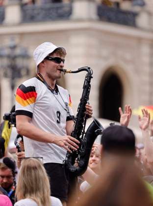 Germany Hesse Frankfurt am Main 23 06 2024 European Football Championship 2024 European Championship type with the saxophone, saxophonist in Völler jersey, Andre Schnura with the black saxophone Sport Public Viewing in Frankfurt