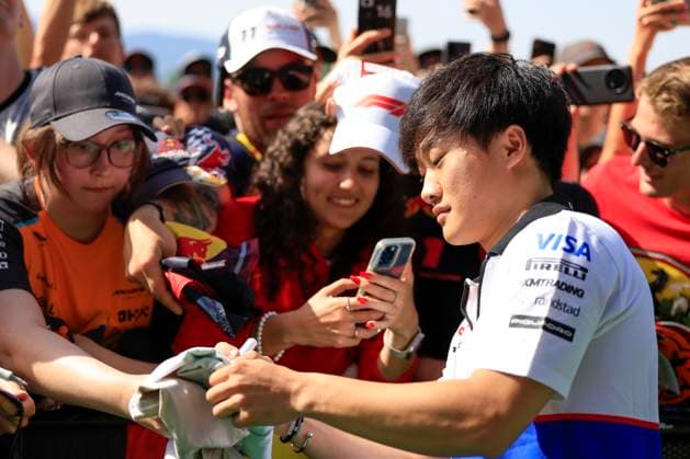 FORMULA 1 - GP of Austria 2024 SPIELBERG,AUSTRIA,30.JUN.24 - MOTORSPORTS, FORMULA 1 - Grand Prix of Austria, Red Bull Ring. Image shows Yuki Tsunoda (JPN VCARB) and fans.  GEPAxpictures xMarioxBuehner-Weinrauch
