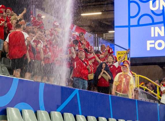 29 06 2024, Football UEFA EURO 2024, Round of 16, Germany Denmark, in the BVB Arena Dortmund, During a heavy thunderstorm over the arena, the water runs in torrents from the roof onto the lower stands Danish fans celebrate the spectacle The match was briefly interrupted