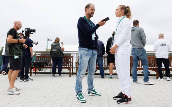Belgian Elise Mertens is interviewed by former Belgian player Filip Dewulf prior to a training session during preparations ahead of the 2024 Wimbledon grand slam tennis tournament at the All England Tennis Club, in south-west London, Britain, Sunday 30 June 2024. BENOITxDOPPAGNE  x95551492x