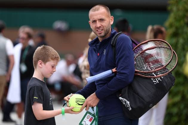 30th June 2024; All England Lawn Tennis and Croquet Club, London, England; Wimbledon Tennis Tournament, Practice Day; Dan Evans (GBR) signs a tennis ball for a fan  ActionPlus12662020 ShaunxBrooks
