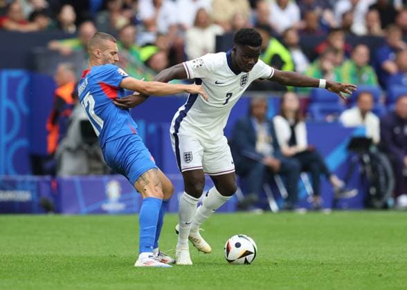 EURO 2024, England - Slowakei Gelsenkirchen, Germany, 30th June 2024. Lukas Haraslin of Slovakia tussles with Bukayo Saka of England during the UEFA European Championships round of 16 match at Arena Aufschalke, Gelsenkirchen. Picture credit should read: Paul Terry Sportimage EDITORIAL USE ONLY. No use with unauthorised audio, video, data, fixture lists, club league logos or live services. Online in-match use limited to 120 images, no video emulation. No use in betting, games or single club league player publications. SPI-3212-0028