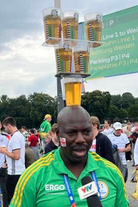 Volunteer wows foreign video teams with his beer cup juggling on his head Cologne 30 06 2024 Spain vs Georgia, EURO2024 M37, round of 16, EM Arena Cologne