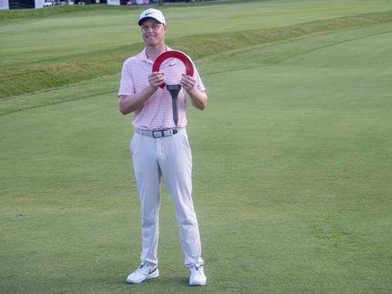 DETROIT, MI - JUNE 30: Cam Davis (AUS) holds up the trophy after winning the fourth round of the Rocket Mortgage Classic on June 30, 2024 at Detroit Golf Club in Detroit, Michigan. (Photo by Joseph Weiser Icon Sportswire) GOLF: JUN 30 PGA, Golf Herren Rocket Mortgage Classic EDITORIAL USE ONLY Icon2406300314