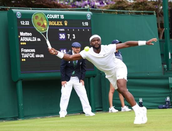 American Frances Tiafoe plays a forehand in his first round match against Italian Matteo Arnaldi on day one of the 2024 Wimbledon Championships in London on Monday, July 01, 2024.  LON2024070107 HUGOxPHILPOTT