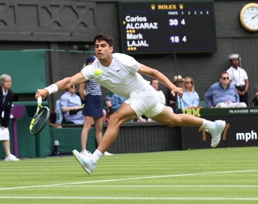 Spain s Carlos Alcaraz plays a forehand in his first round match against Estonian Mark Laval on day one of the 2024 Wimbledon Championships in London on Monday, July 01, 2024.  LON2024070121 HUGOxPHILPOTT