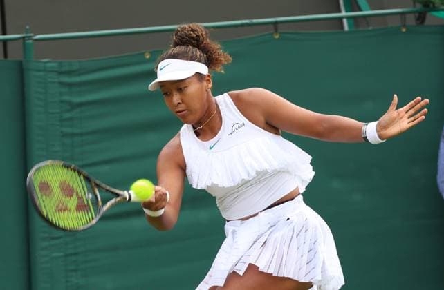 Japan s Naomi Osaka plays a forehand in her first round match against France s Diane Parry on day one of the 2024 Wimbledon Championships in London on Monday, July 01, 2024.  LON2024070134 HUGOxPHILPOTT