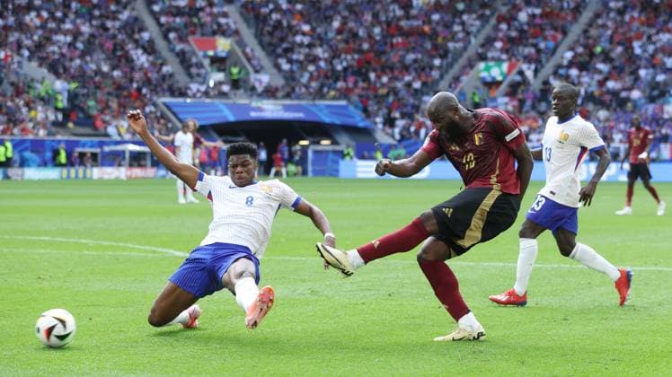 Dusseldorf, Germany, 1st July 2024. Romelu Lukaku of Belgium (C) shoots past Aurelien Tchouameni of France (L) during the UEFA European Championships Round of 16 match at Dusseldorf Arena, Dusseldorf. Picture credit should read: Paul Terry Sportimage EDITORIAL USE ONLY. No use with unauthorised audio, video, data, fixture lists, club league logos or live services. Online in-match use limited to 120 images, no video emulation. No use in betting, games or single club league player publications. SPI-3216-0065
