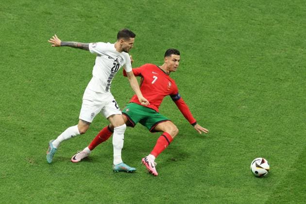 Cristiano Ronaldo of Portugal and Petar Stojanovic of Slovenia Portugal v Slovenia, UEFA European Championship, EM, Europameisterschaft 2024, Round of 16, Football, Frankfurt Arena, Frankfurt, Germany - 01 Jul 2024 EDITORIAL USE ONLY No use with unauthorised audio, video, data, fixture lists, club league logos or live services. Online in-match use limited to 120 images, no video emulation. No use in betting, games or single club league player publications. Copyright: xPaulxCurrie Shutterstockx 14566636ae