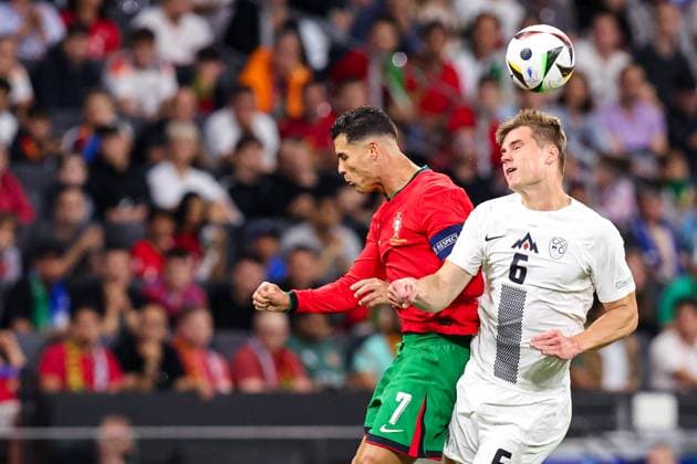 2024-07-01 Portugal v Slovenia - Round of 16 - UEFA EURO, EM, Europameisterschaft,Fussball 2024 FRANKFURT, GERMANY - JULY 1: Cristiano Ronaldo of Portugal heads the ball with Jaka Bijol of Slovenia during the Round of 16 - UEFA EURO 2024 match between Portugal and Slovenia at Deutsche Bank Park on July 1, 2024 in Frankfurt, Germany. (Photo by Peter Lous BSR Agency) Frankfurt Germany Content not available for redistribution in The Netherlands directly or indirectly through any third parties. Copyright: xBSRxAgencyx
