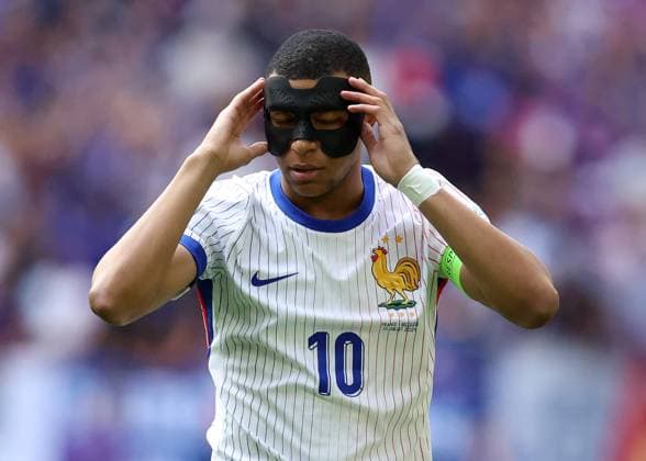 Dusseldorf, Germany, 1st July 2024. Kylan Mbappe of France adjusts his protective face mask during the UEFA European Championships Round of 16 match at Dusseldorf Arena, Dusseldorf. Picture credit should read: Paul Terry Sportimage EDITORIAL USE ONLY. No use with unauthorised audio, video, data, fixture lists, club league logos or live services. Online in-match use limited to 120 images, no video emulation. No use in betting, games or single club league player publications. SPI-3216-0243
