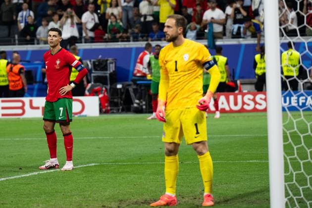 (240702) -- FRANKFURT, July 2, 2024 -- Cristiano Ronaldo (L) of Portugal reacts after his penalty kick is saved by Slovenia s goalkeeper Jan Oblak during the UEFA EURO, EM, Europameisterschaft,Fussball 2024 Round of 16 match between Portugal and Slovenia in Frankfurt, Germany on July 1, 2024. ) (SP)GERMANY-FRANKFURT-FOOTBALL-EURO 2024-PORTUGAL VS SLOVENIA XiaoxYijiu 