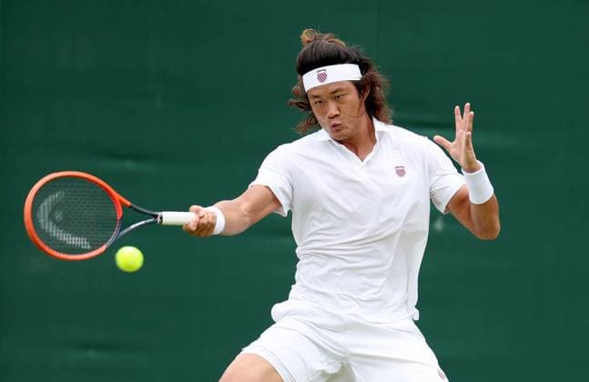 (240702) -- LONDON, July 2, 2024 -- Zhang Zhizhen hits a return during the men s singles first round match between Zhang Zhizhen of China and Maxime Janvier of France at Wimbledon tennis Championship in London, Britain, on July 1, 2024. ) (SP)BRITAIN-LONDON-TENNIS-WIMBLEDON LixYing 