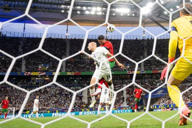 (240702) -- FRANKFURT, July 2, 2024 -- Cristiano Ronaldo (top) of Portugal vies for a header with Vanja Drkusic of Slovenia during the UEFA EURO, EM, Europameisterschaft,Fussball 2024 Round of 16 match between Portugal and Slovenia in Frankfurt, Germany on July 1, 2024. ) (SP)GERMANY-FRANKFURT-FOOTBALL-EURO 2024-PORTUGAL VS SLOVENIA XiaoxYijiu 