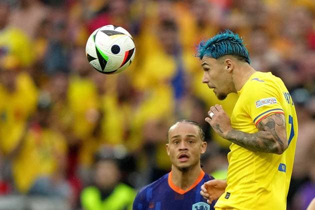 Xavi Simons of the Netherlands fight for the ball with Romania s Andrei Ratiu during the Euro 2024 soccer match between Romania and Netherlands at the Munich Football Arena , Munich , Germany - Tuesday July 2 , 2024. - Soccer .  Copyright: xSpada LaPressex